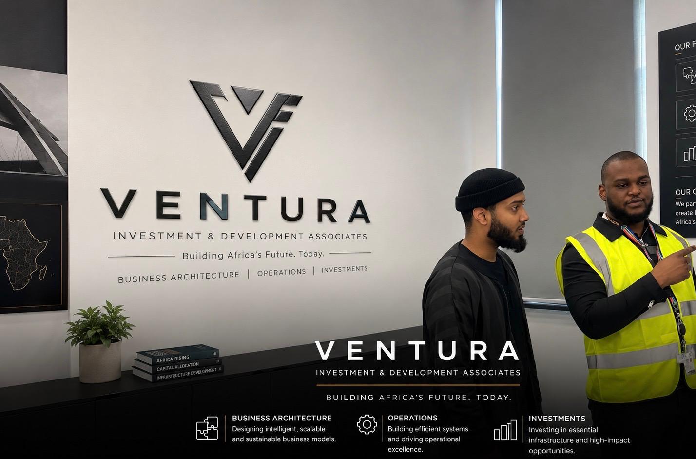 The Ventura Investment & Development Associates signage wall at the firm's Johannesburg offices, with two colleagues in conversation beside it.